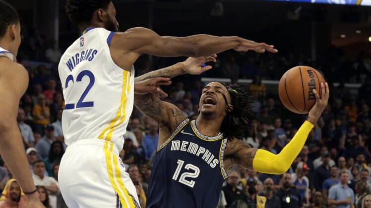 May 3, 2022; Memphis, Tennessee, USA; Memphis Grizzlies guard Ja Morant (12) drives to the basket as Golden State Warriors forward Andrew Wiggins (22) defends during the first half in game two of the second round for the 2022 NBA playoffs at FedExForum. Mandatory Credit: Petre Thomas-USA TODAY Sports