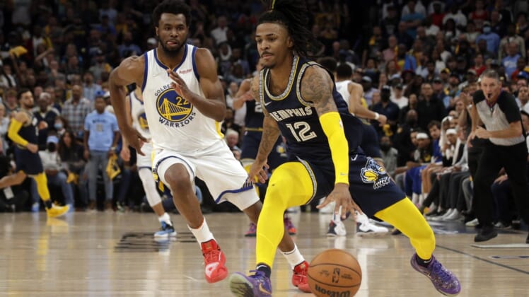 May 3, 2022; Memphis, Tennessee, USA; Memphis Grizzlies guard Ja Morant (12) dribbles the ball as Golden State Warriors forward Andrew Wiggins (22) defends during the second half in game two of the second round for the 2022 NBA playoffs at FedExForum. Mandatory Credit: Petre Thomas-USA TODAY Sports