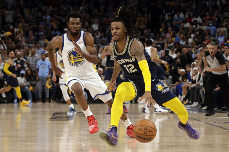 May 3, 2022; Memphis, Tennessee, USA; Memphis Grizzlies guard Ja Morant (12) dribbles the ball as Golden State Warriors forward Andrew Wiggins (22) defends during the second half in game two of the second round for the 2022 NBA playoffs at FedExForum. Mandatory Credit: Petre Thomas-USA TODAY Sports