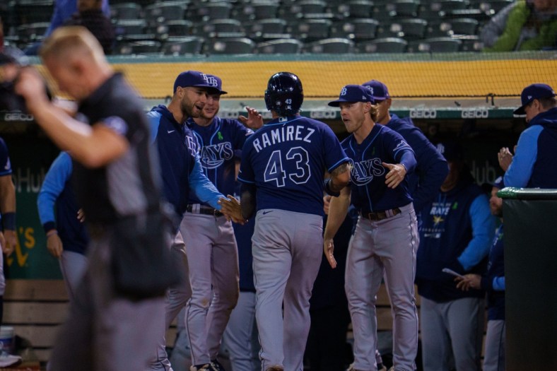 May 3, 2022; Oakland, California, USA; Tampa Bay Rays left fielder Harold Ramirez (43) and teammates celebrate after the score during the tenth inning against the Oakland Athletics at RingCentral Coliseum. Mandatory Credit: Neville E. Guard-USA TODAY Sports