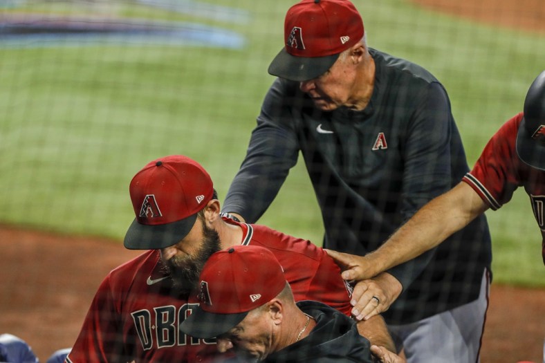 May 4, 2022; Miami, Florida, USA; Arizona Diamondbacks starting pitcher Madison Bumgarner (40) gets taken out of the game after getting ejected from the game during the first inning against the Miami Marlins at loanDepot Park. Mandatory Credit: Sam Navarro-USA TODAY Sports