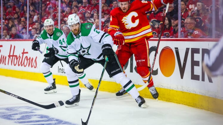 May 3, 2022; Calgary, Alberta, CAN; Dallas Stars defenseman Jani Hakanpaa (2) and Calgary Flames right wing Brett Ritchie (24) battle for the puck during the third period in game one of the first round of the 2022 Stanley Cup Playoffs at Scotiabank Saddledome. Mandatory Credit: Sergei Belski-USA TODAY Sports