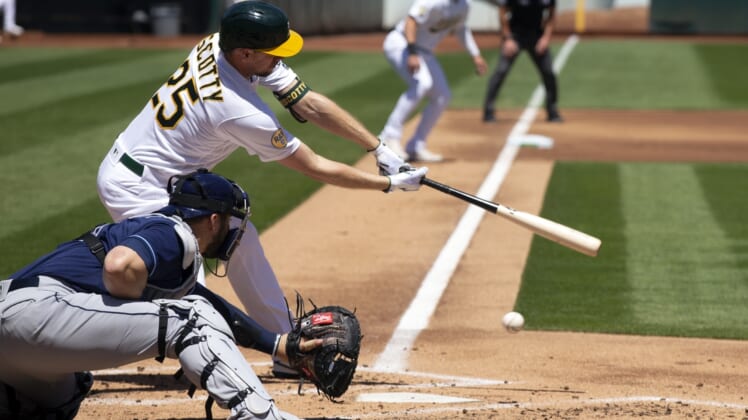 May 4, 2022; Oakland, California, USA; Oakland Athletics right fielder Stephen Piscotty (25) swings and misses at strike three as Tampa Bay Rays catcher Mike Zunino (10) catches the pitch during the second inning at RingCentral Coliseum. Mandatory Credit: D. Ross Cameron-USA TODAY Sports