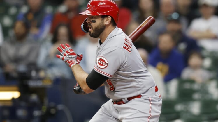 May 4, 2022; Milwaukee, Wisconsin, USA;  Cincinnati Reds designated hitter Mike Moustakas (9) hits an RBI single during the first inning against the Milwaukee Brewers at American Family Field. Mandatory Credit: Jeff Hanisch-USA TODAY Sports