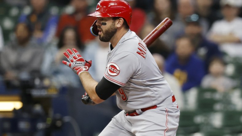 May 4, 2022; Milwaukee, Wisconsin, USA;  Cincinnati Reds designated hitter Mike Moustakas (9) hits an RBI single during the first inning against the Milwaukee Brewers at American Family Field. Mandatory Credit: Jeff Hanisch-USA TODAY Sports