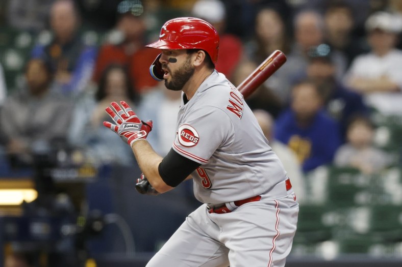 May 4, 2022; Milwaukee, Wisconsin, USA;  Cincinnati Reds designated hitter Mike Moustakas (9) hits an RBI single during the first inning against the Milwaukee Brewers at American Family Field. Mandatory Credit: Jeff Hanisch-USA TODAY Sports