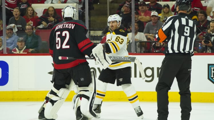 May 4, 2022; Raleigh, North Carolina, USA; Boston Bruins left wing Brad Marchand (63) swings his stick at Carolina Hurricanes goaltender Pyotr Kochetkov (52) during the second period in game two of the first round of the 2022 Stanley Cup Playoffs at PNC Arena. Mandatory Credit: James Guillory-USA TODAY Sports