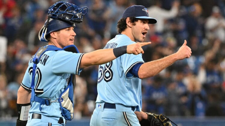 May 4, 2022; Toronto, Ontario, CAN;  Toronto Blue Jays relief pitcher Jordan Romano (68) and catcher Tyler Heineman (22) react after the final out as the Jays defeat the New York Yankees at Rogers Centre. Mandatory Credit: Dan Hamilton-USA TODAY Sports