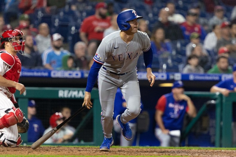 May 4, 2022; Philadelphia, Pennsylvania, USA; Texas Rangers second baseman Brad Miller (13) hits a two RBI single against the Philadelphia Phillies during the tenth inning at Citizens Bank Park. Mandatory Credit: Bill Streicher-USA TODAY Sports