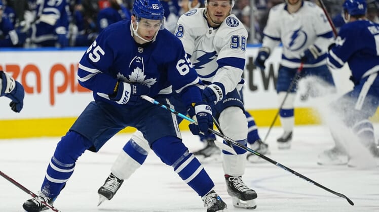 May 4, 2022; Toronto, Ontario, CAN; Tampa Bay Lightning defenseman Mikhail Sergachev (98) tries to knock the puck away from Toronto Maple Leafs forward Ilya Mikheyev (65) during the first period of game two of the first round of the 2022 Stanley Cup Playoffs at Scotiabank Arena. Mandatory Credit: John E. Sokolowski-USA TODAY Sports