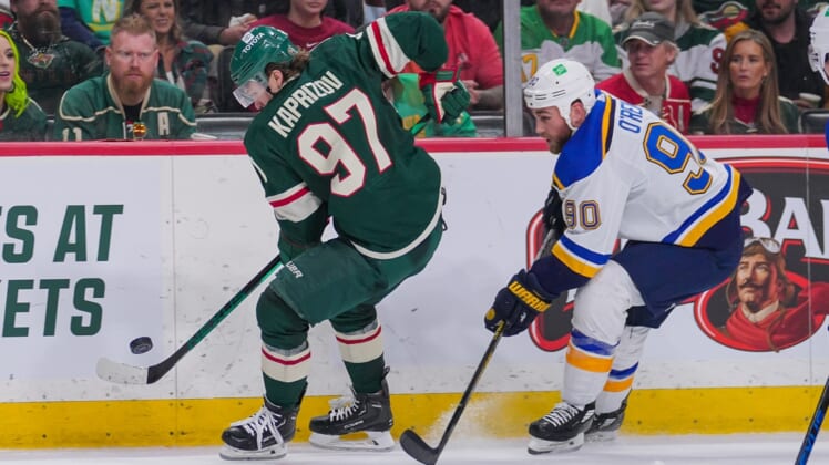 May 4, 2022; Saint Paul, Minnesota, USA; Minnesota Wild left wing Kirill Kaprizov (97) skates with the puck against the St. Louis Blues center Ryan O'Reilly (90) in the second period in game two of the first round of the 2022 Stanley Cup Playoffs at Xcel Energy Center. Mandatory Credit: Brad Rempel-USA TODAY Sports
