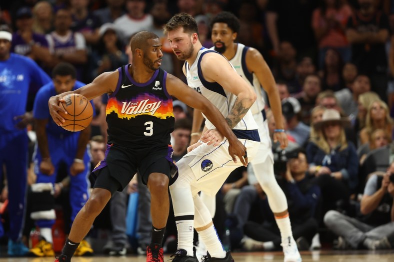 May 4, 2022; Phoenix, Arizona, USA; Phoenix Suns guard Chris Paul (3) moves the ball against Dallas Mavericks guard Luka Doncic (77) during the second half in game two of the second round for the 2022 NBA playoffs at Footprint Center. Mandatory Credit: Mark J. Rebilas-USA TODAY Sports