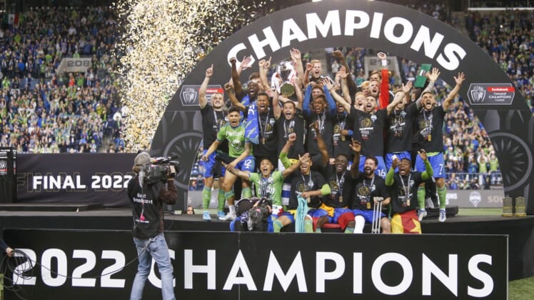 May 4, 2022; Seattle, WA, USA; Seattle Sounders FC players, including midfielder Nicolas Lodeiro (10, holding trophy) celebrate after defeating Pumas 3-0 in the second leg of the Concacaf Champions League Final at Lumen Field. Mandatory Credit: Joe Nicholson-USA TODAY Sports