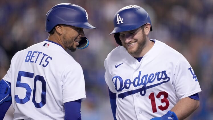 May 4, 2022; Los Angeles, California, USA; Los Angeles Dodgers third baseman Max Muncy (13) celebrates with right fielder Mookie Betts (50) after scoring in the seventh inning against the San Francisco Giants at Dodger Stadium. Mandatory Credit: Kirby Lee-USA TODAY Sports