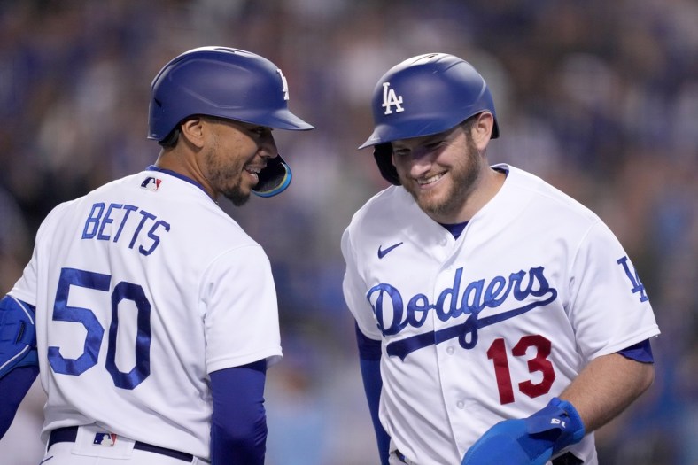 May 4, 2022; Los Angeles, California, USA; Los Angeles Dodgers third baseman Max Muncy (13) celebrates with right fielder Mookie Betts (50) after scoring in the seventh inning against the San Francisco Giants at Dodger Stadium. Mandatory Credit: Kirby Lee-USA TODAY Sports