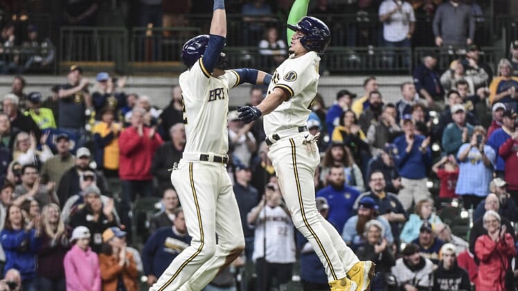 May 5, 2022; Milwaukee, Wisconsin, USA; Milwaukee Brewers shortstop Willy Adames (27) celebrates with left fielder Christian Yelich (22) after hitting a 2-run homer in the second inning against the Cincinnati Reds  at American Family Field. Mandatory Credit: Benny Sieu-USA TODAY Sports