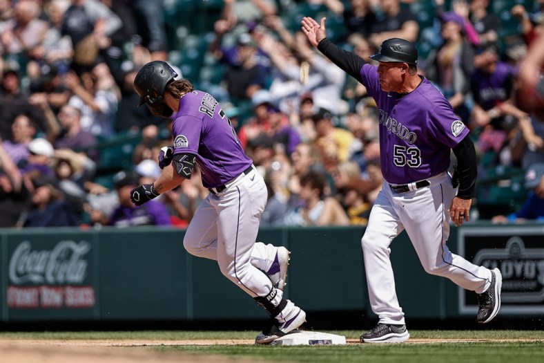 May 5, 2022; Denver, Colorado, USA; Colorado Rockies second baseman Brendan Rodgers (7) celebrates with first base coach Ronnie Gideon (53) after hitting a three run home run in the fifth inning against the Washington Nationals at Coors Field. Mandatory Credit: Isaiah J. Downing-USA TODAY Sports