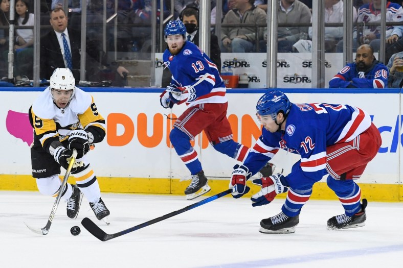 May 5, 2022; New York, New York, USA; New York Rangers center Filip Chytil (72) and Pittsburgh Penguins center Evan Rodrigues (9) reach for a loose puck during the first period in game two of the first round of the 2022 Stanley Cup Playoffs at Madison Square Garden. Mandatory Credit: Dennis Schneidler-USA TODAY Sports