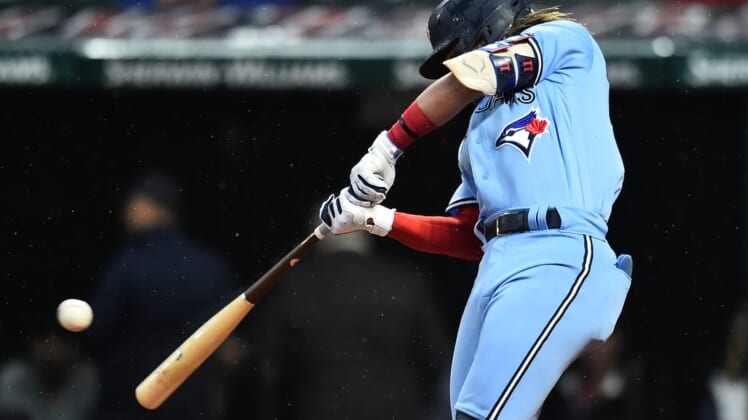 May 5, 2022; Cleveland, Ohio, USA; Toronto Blue Jays shortstop Bo Bichette (11) hits a single during the sixth inning against the Cleveland Guardians at Progressive Field. Mandatory Credit: Ken Blaze-USA TODAY Sports