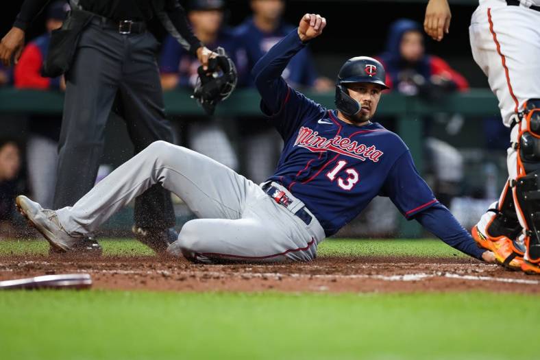 May 5, 2022; Baltimore, Maryland, USA; Minnesota Twins left fielder Trevor Larnach (13) scores a run against the Baltimore Orioles during the third inning at Oriole Park at Camden Yards. Mandatory Credit: Scott Taetsch-USA TODAY Sports