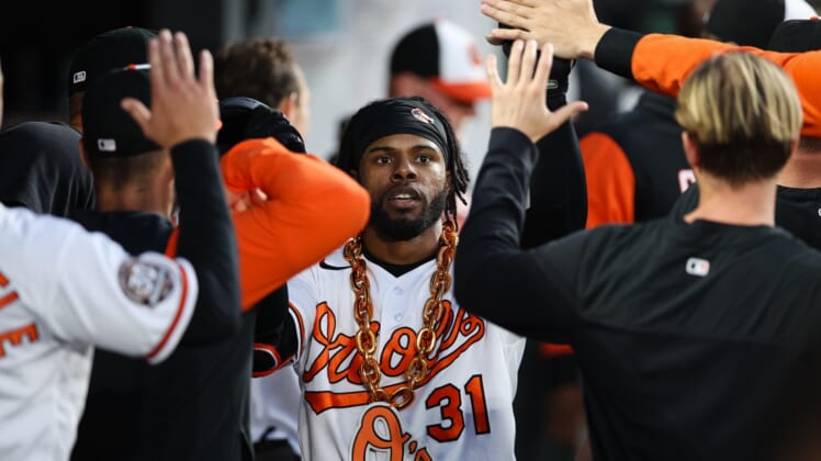 May 5, 2022; Baltimore, Maryland, USA; Baltimore Orioles center fielder Cedric Mullins (31) celebrates with teammates and a gold chain after hitting hitting a home run against the Minnesota Twins during the third inning at Oriole Park at Camden Yards. Mandatory Credit: Scott Taetsch-USA TODAY Sports