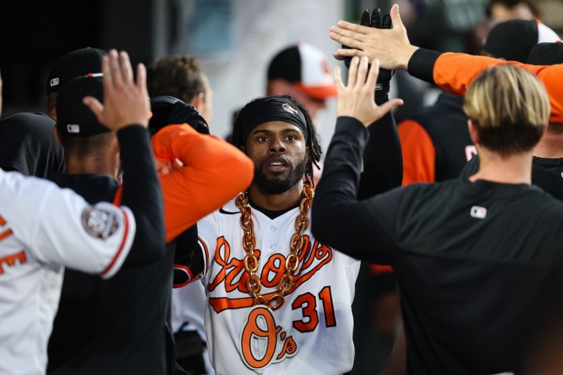 May 5, 2022; Baltimore, Maryland, USA; Baltimore Orioles center fielder Cedric Mullins (31) celebrates with teammates and a gold chain after hitting hitting a home run against the Minnesota Twins during the third inning at Oriole Park at Camden Yards. Mandatory Credit: Scott Taetsch-USA TODAY Sports