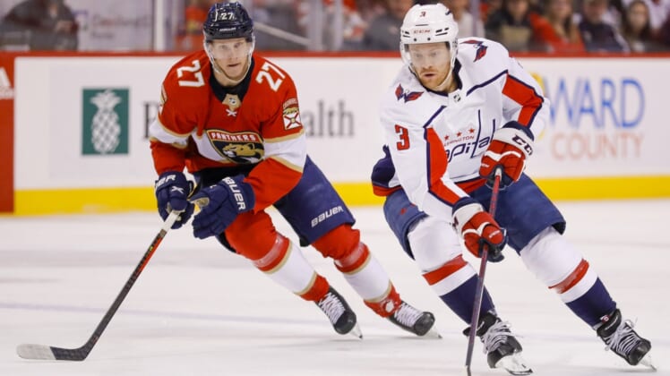 May 5, 2022; Sunrise, Florida, USA; Washington Capitals defenseman Nick Jensen (3) moves the puck ahed of Florida Panthers center Eetu Luostarinen (27) during the first period in game two of the first round of the 2022 Stanley Cup Playoffs at FLA Live Arena. Mandatory Credit: Sam Navarro-USA TODAY Sports