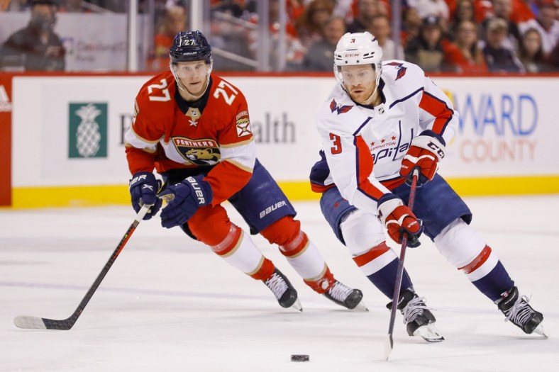 May 5, 2022; Sunrise, Florida, USA; Washington Capitals defenseman Nick Jensen (3) moves the puck ahed of Florida Panthers center Eetu Luostarinen (27) during the first period in game two of the first round of the 2022 Stanley Cup Playoffs at FLA Live Arena. Mandatory Credit: Sam Navarro-USA TODAY Sports