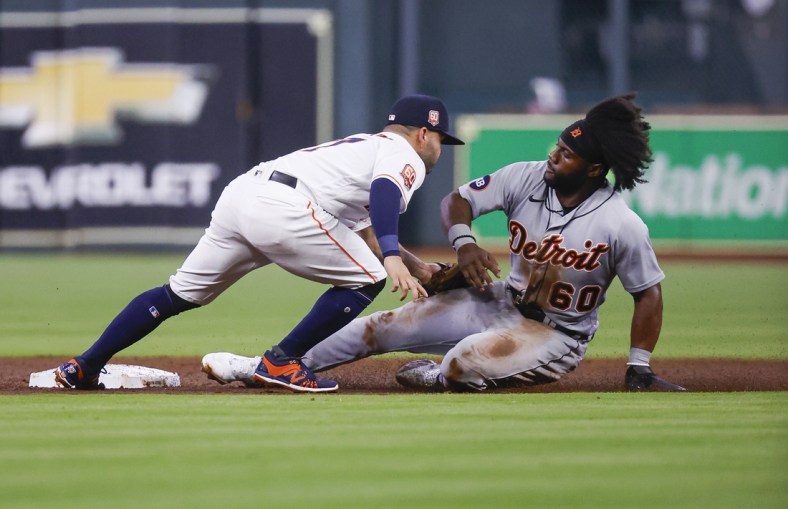 May 5, 2022; Houston, Texas, USA; Detroit Tigers center fielder Akil Baddoo (60) is tagged out by Houston Astros second baseman Jose Altuve (27) on a play during the third inning at Minute Maid Park. Mandatory Credit: Troy Taormina-USA TODAY Sports