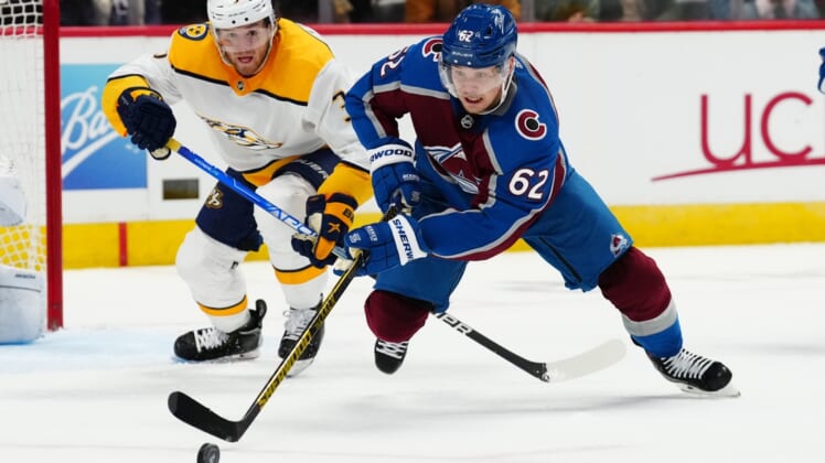 May 5, 2022; Denver, Colorado, USA; Nashville Predators defenseman Jeremy Lauzon (3) and Colorado Avalanche left wing Artturi Lehkonen (62) reach for the puck in the second period of game two of the first round of the 2022 Stanley Cup Playoffs at Ball Arena. Mandatory Credit: Ron Chenoy-USA TODAY Sports