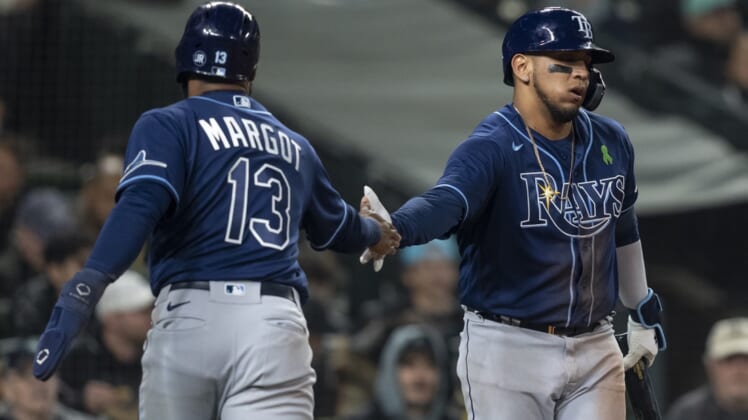 May 5, 2022; Seattle, Washington, USA; Tampa Bay Rays rightfielder Manuel Margot (13) is congratulated by third baseman Isaac Paredes (17) after scoring a run during the fourth inning against the Seattle Mariners  at T-Mobile Park. Mandatory Credit: Stephen Brashear-USA TODAY Sports