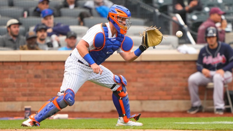 May 4, 2022; New York City, New York, USA; New York Mets catcher James McCann (33) catches a throw from New York Mets right fielder Starling Marte (6) (not pictured) during the sixth inning against the Atlanta Braves at Citi Field. Mandatory Credit: Gregory Fisher-USA TODAY Sports