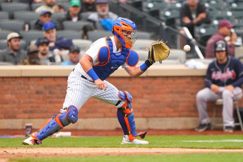 May 4, 2022; New York City, New York, USA; New York Mets catcher James McCann (33) catches a throw from New York Mets right fielder Starling Marte (6) (not pictured) during the sixth inning against the Atlanta Braves at Citi Field. Mandatory Credit: Gregory Fisher-USA TODAY Sports