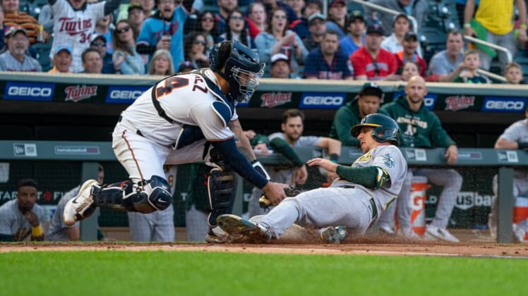 May 6, 2022; Minneapolis, Minnesota, USA; Minnesota Twins catcher Gary Sanchez (24) tags out Oakland Athletics right fielder Stephen Piscotty (25) at home plate during the second inning at Target Field. Mandatory Credit: Jordan Johnson-USA TODAY Sports