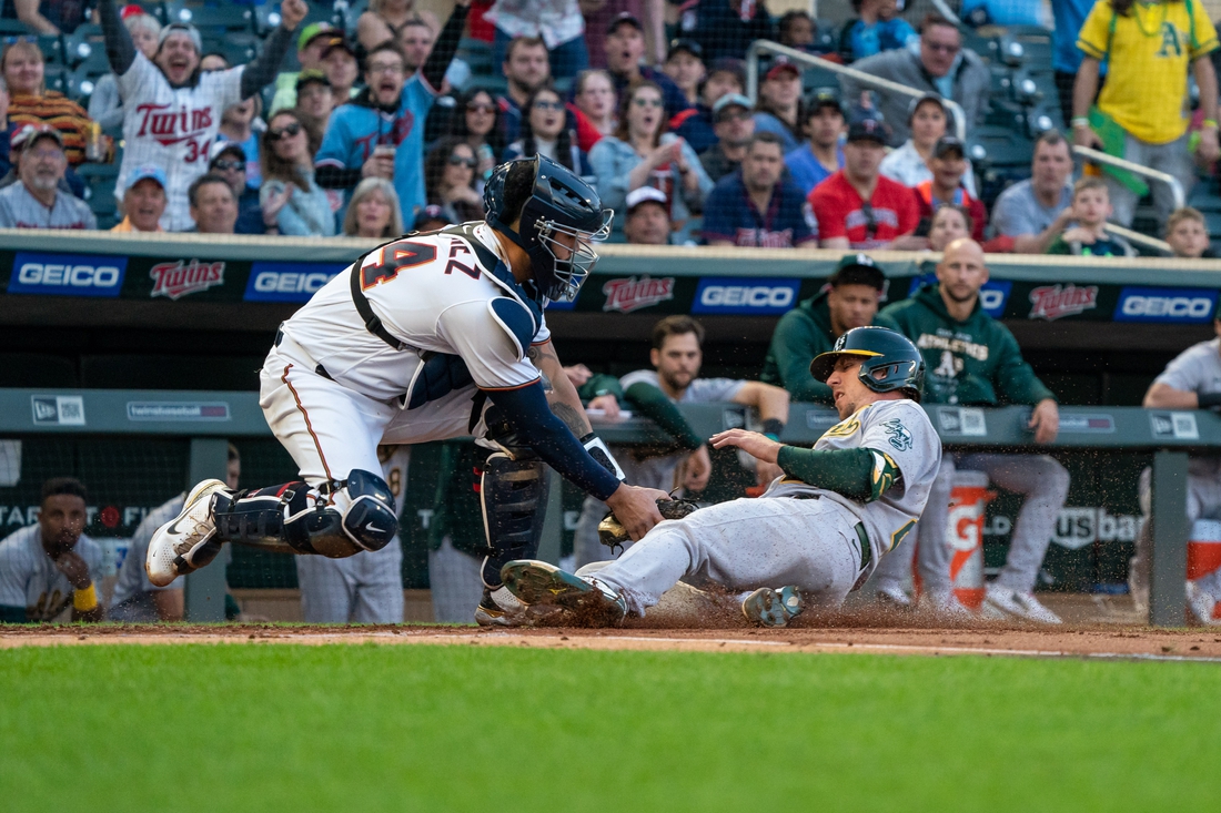 May 6, 2022; Minneapolis, Minnesota, USA; Minnesota Twins catcher Gary Sanchez (24) tags out Oakland Athletics right fielder Stephen Piscotty (25) at home plate during the second inning at Target Field. Mandatory Credit: Jordan Johnson-USA TODAY Sports