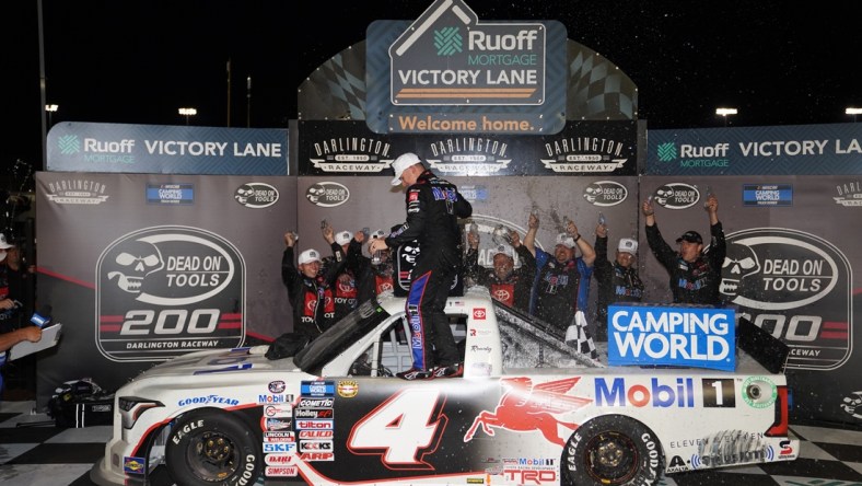 May 6, 2022; Darlington, South Carolina, USA; NASCAR Truck Series driver John Hunter Nemechek (4) celebrates winning the Dead On Tools 200 at Darlington Raceway. Mandatory Credit: Jasen Vinlove-USA TODAY Sports