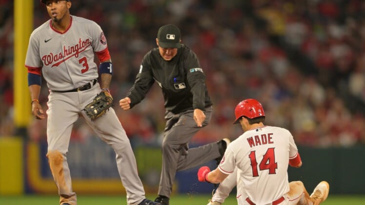 May 6, 2022; Anaheim, California, USA;  Umpire Adam Hamari (78) calls Los Angeles Angels second baseman Tyler Wade (14) out on an attempted steal as he is tagged by Washington Nationals shortstop Alcides Escobar (3) after he slid past the base in the seventh inning at Angel Stadium. Mandatory Credit: Jayne Kamin-Oncea-USA TODAY Sports
