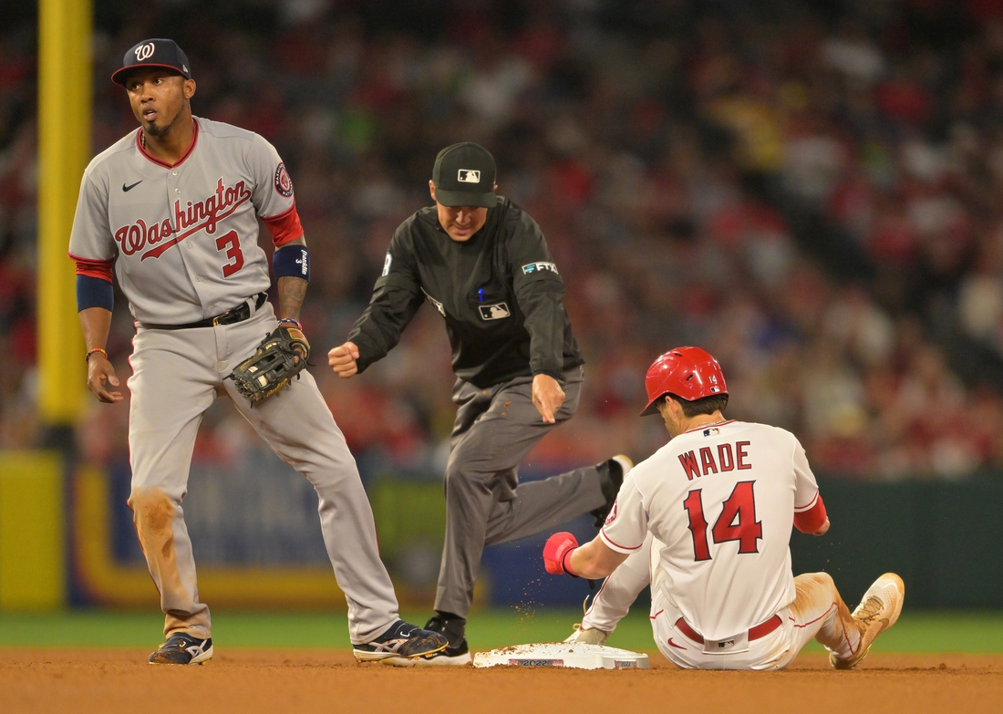 May 6, 2022; Anaheim, California, USA;  Umpire Adam Hamari (78) calls Los Angeles Angels second baseman Tyler Wade (14) out on an attempted steal as he is tagged by Washington Nationals shortstop Alcides Escobar (3) after he slid past the base in the seventh inning at Angel Stadium. Mandatory Credit: Jayne Kamin-Oncea-USA TODAY Sports