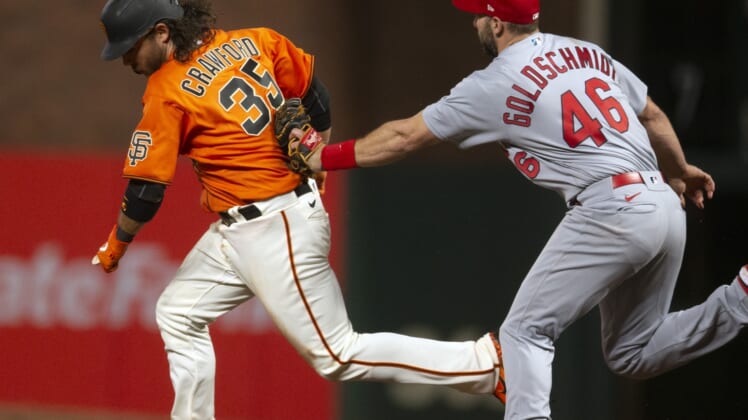 May 6, 2022; San Francisco, California, USA; St. Louis Cardinals first baseman Paul Goldschmidt (46) puts the tag on San Francisco Giants shortstop Brandon Crawford (35) after he was caught in a rundown between first and second base during the sixth inning at Oracle Park. Mandatory Credit: D. Ross Cameron-USA TODAY Sports