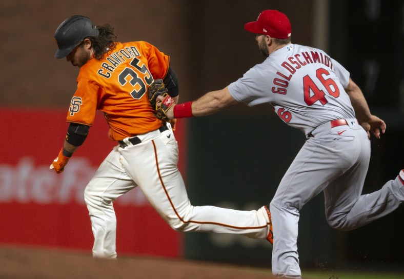 May 6, 2022; San Francisco, California, USA; St. Louis Cardinals first baseman Paul Goldschmidt (46) puts the tag on San Francisco Giants shortstop Brandon Crawford (35) after he was caught in a rundown between first and second base during the sixth inning at Oracle Park. Mandatory Credit: D. Ross Cameron-USA TODAY Sports