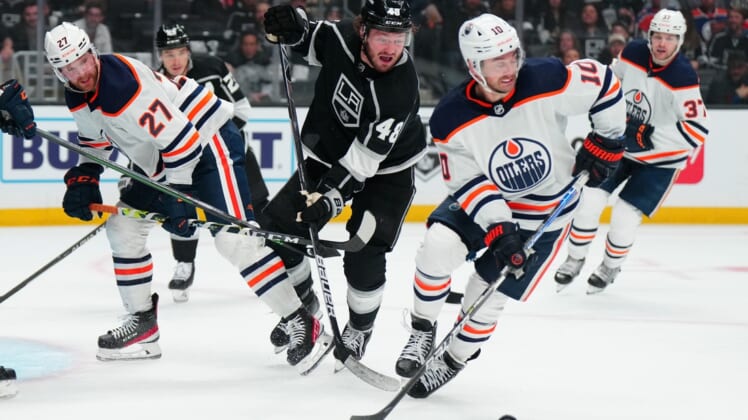 May 6, 2022; Los Angeles, California, USA; Edmonton Oilers defenseman Brett Kulak (27) and center Derek Ryan (10) battle for the puck with LA Kings left wing Brendan Lemieux (48) in the second period of game three of the first round of the 2022 Stanley Cup Playoffs at Crypto.com Arena. Mandatory Credit: Kirby Lee-USA TODAY Sports
