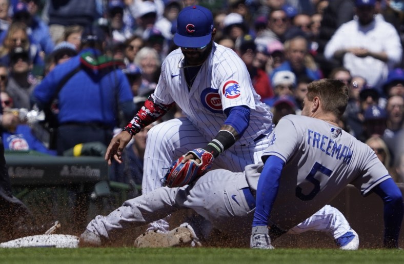 May 7, 2022; Chicago, Illinois, USA;Los Angeles Dodgers first baseman Freddie Freeman (5) is safe at third bases Chicago Cubs third baseman Jonathan Villar (24) makes a late tag during the first inning at Wrigley Field. Mandatory Credit: David Banks-USA TODAY Sports