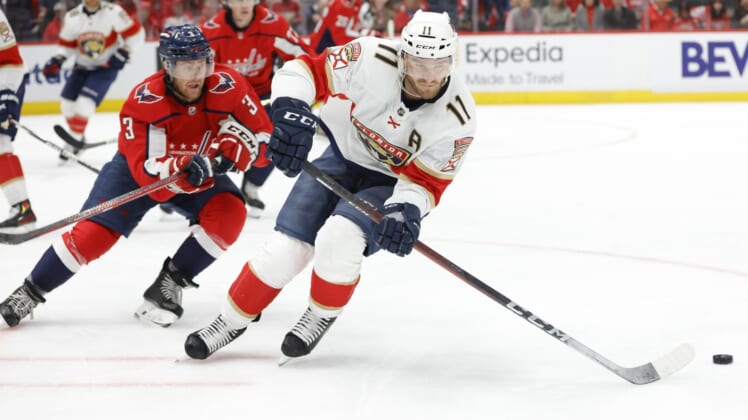 May 7, 2022; Washington, District of Columbia, USA; Florida Panthers left wing Jonathan Huberdeau (11) skates with the puck as Washington Capitals defenseman Nick Jensen (3) chases in the second period in game three of the first round of the 2022 Stanley Cup Playoffs at Capital One Arena. Mandatory Credit: Geoff Burke-USA TODAY Sports