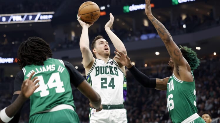 May 7, 2022; Milwaukee, Wisconsin, USA; Milwaukee Bucks guard Pat Connaughton (24) shoots against Boston Celtics guard Marcus Smart (36) during the first quarter during game three of the second round for the 2022 NBA playoffs at Fiserv Forum. Mandatory Credit: Jeff Hanisch-USA TODAY Sports