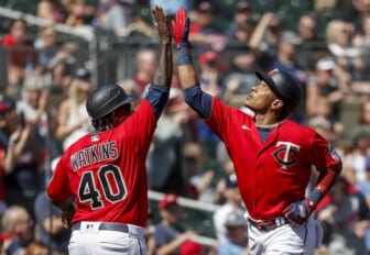 May 7, 2022; Minneapolis, Minnesota, USA; Minnesota Twins second baseman Jorge Polanco (11) celebrates with third base coach Tommy Watkins his a solo home run against the Oakland Athletics in the sixth inning at Target Field. Mandatory Credit: Bruce Kluckhohn-USA TODAY Sports
