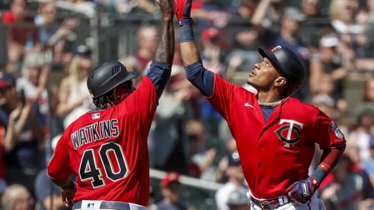 May 7, 2022; Minneapolis, Minnesota, USA; Minnesota Twins second baseman Jorge Polanco (11) celebrates with third base coach Tommy Watkins his a solo home run against the Oakland Athletics in the sixth inning at Target Field. Mandatory Credit: Bruce Kluckhohn-USA TODAY Sports