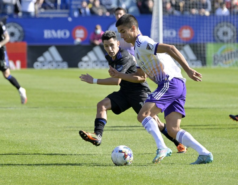 May 7, 2022; Montreal, Quebec, CAN; Orlando City SC defender Joao Moutinho (4) plays the ball and CF Montreal midfielder Joaquin Torres (10) defends during the first half at Stade Saputo. Mandatory Credit: Eric Bolte-USA TODAY Sports