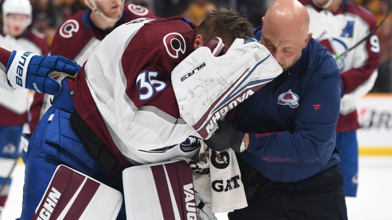 May 7, 2022; Nashville, Tennessee, USA; Colorado Avalanche goaltender Darcy Kuemper (35) is helped off the ice after an injury during the first period against the Nashville Predators in game three of the first round of the 2022 Stanley Cup Playoffs at Bridgestone Arena. Mandatory Credit: Christopher Hanewinckel-USA TODAY Sports