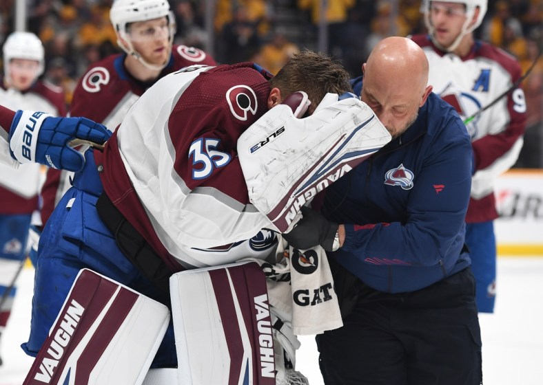 May 7, 2022; Nashville, Tennessee, USA; Colorado Avalanche goaltender Darcy Kuemper (35) is helped off the ice after an injury during the first period against the Nashville Predators in game three of the first round of the 2022 Stanley Cup Playoffs at Bridgestone Arena. Mandatory Credit: Christopher Hanewinckel-USA TODAY Sports