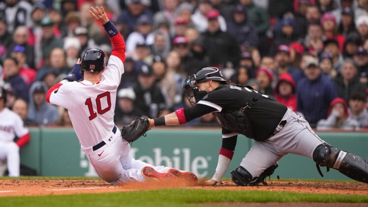 May 7, 2022; Boston, Massachusetts, USA;  Chicago White Sox catcher Yasmani Grandal (24) tags out Boston Red Sox second baseman Trevor Story (10) attempting to score on a ground ball during the fifth inning at Fenway Park. Mandatory Credit: Gregory Fisher-USA TODAY Sports